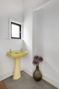 Cloakroom with existing reused sanitaryware