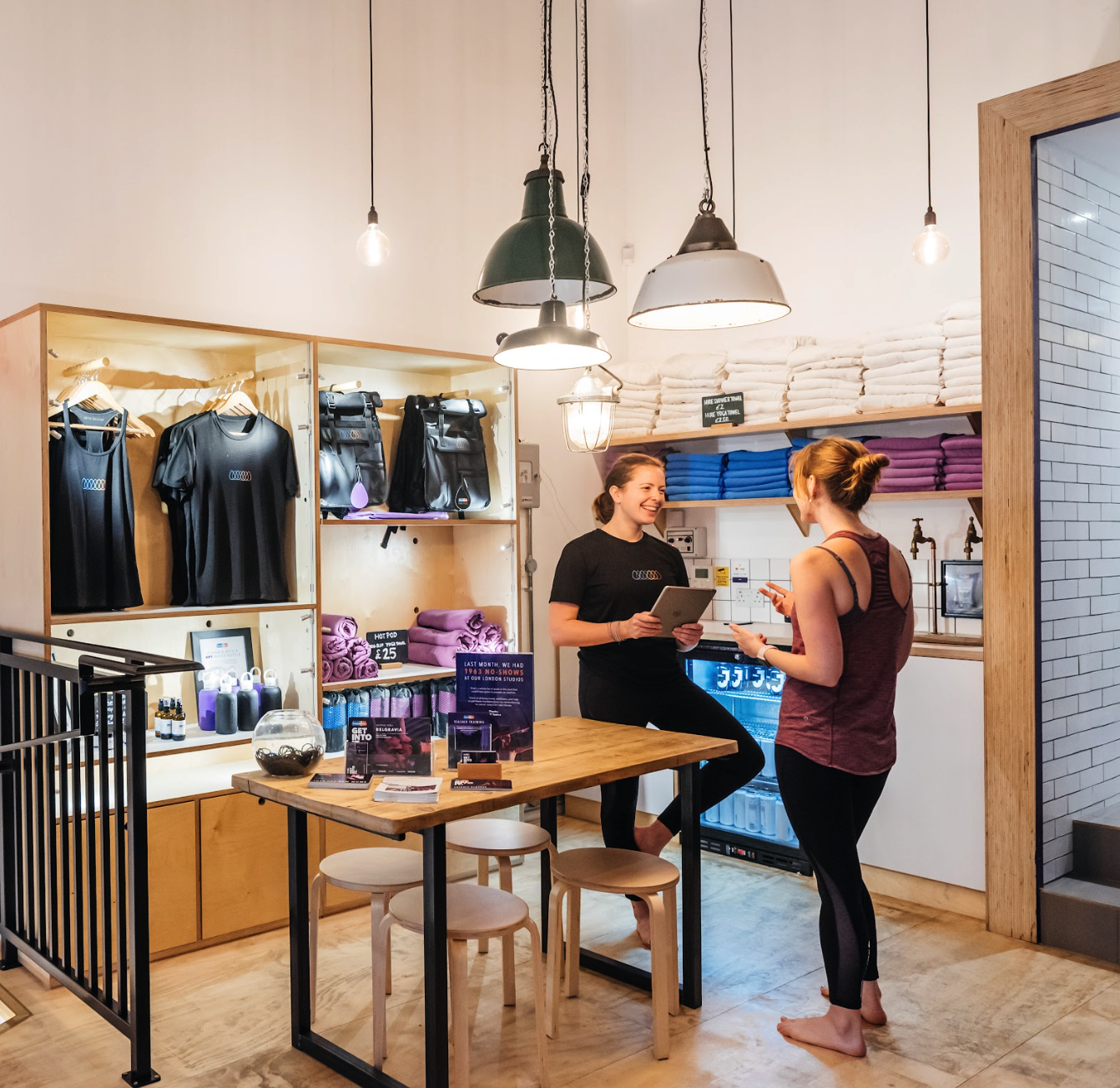 two people dressed in sports clothes in a shop