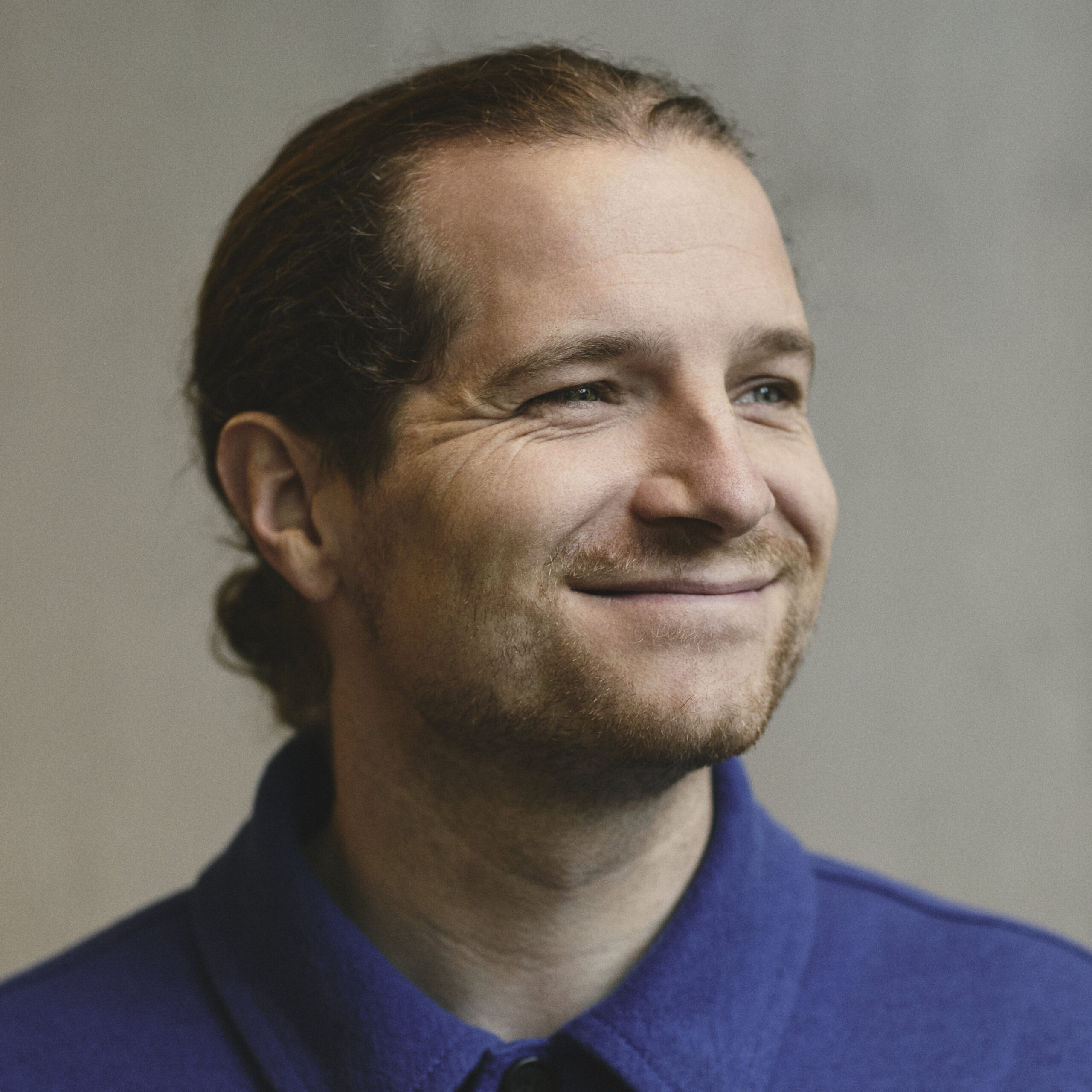 Smiling man looks off camera