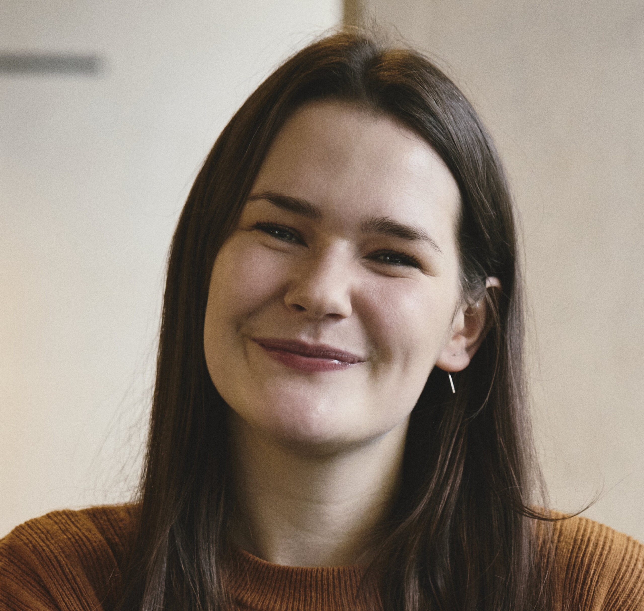 Woman smiles and looks straight at the camera