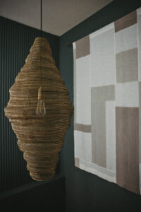 A sculptural beehive light fitting from Industville hangs in the stairwell, joined by a Pojagi inspired artwork, handmade by Tavana Studio.