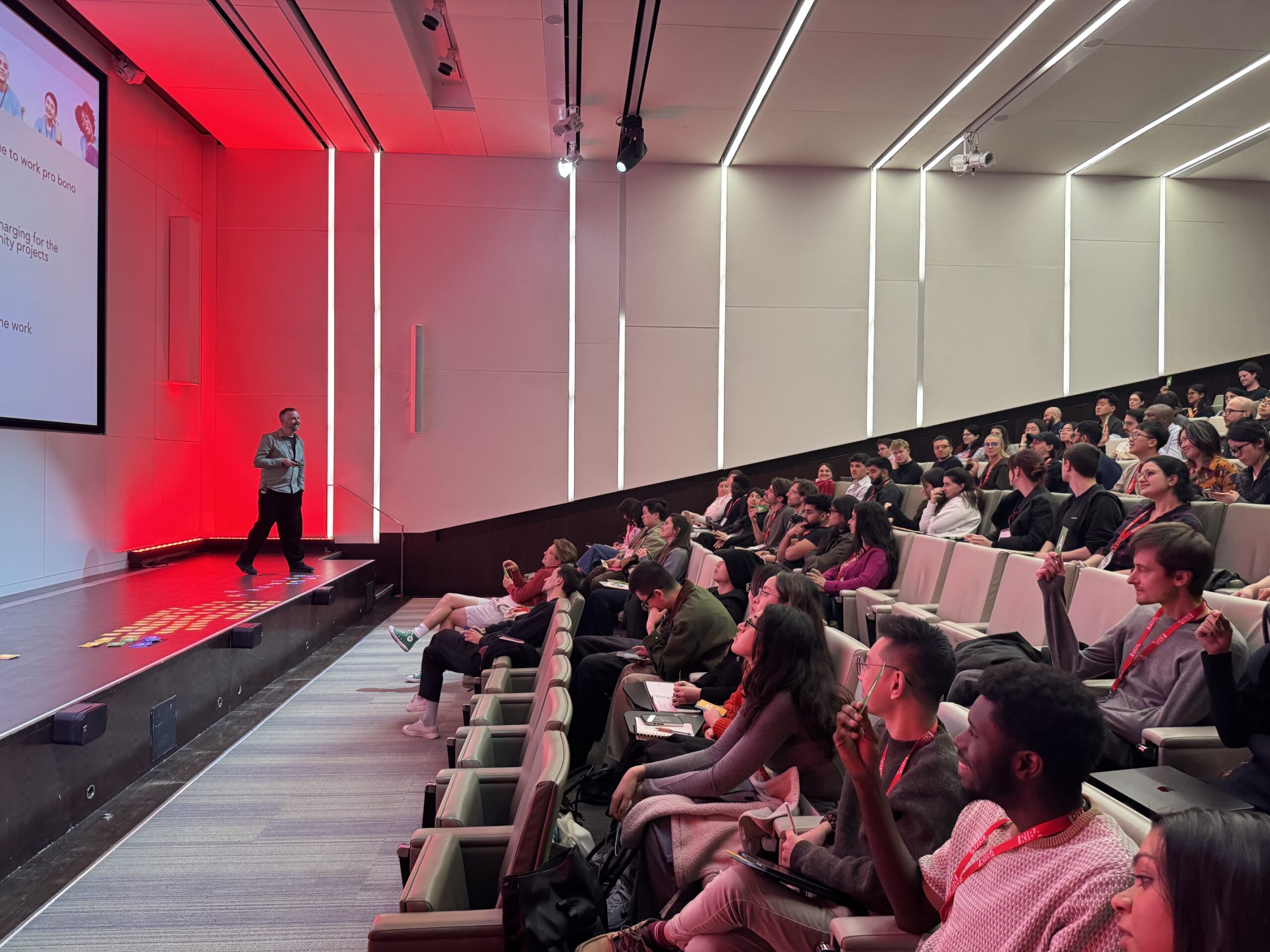 a lecture theatre full of architecture students. Alasdair Ben Dixon presents from the front